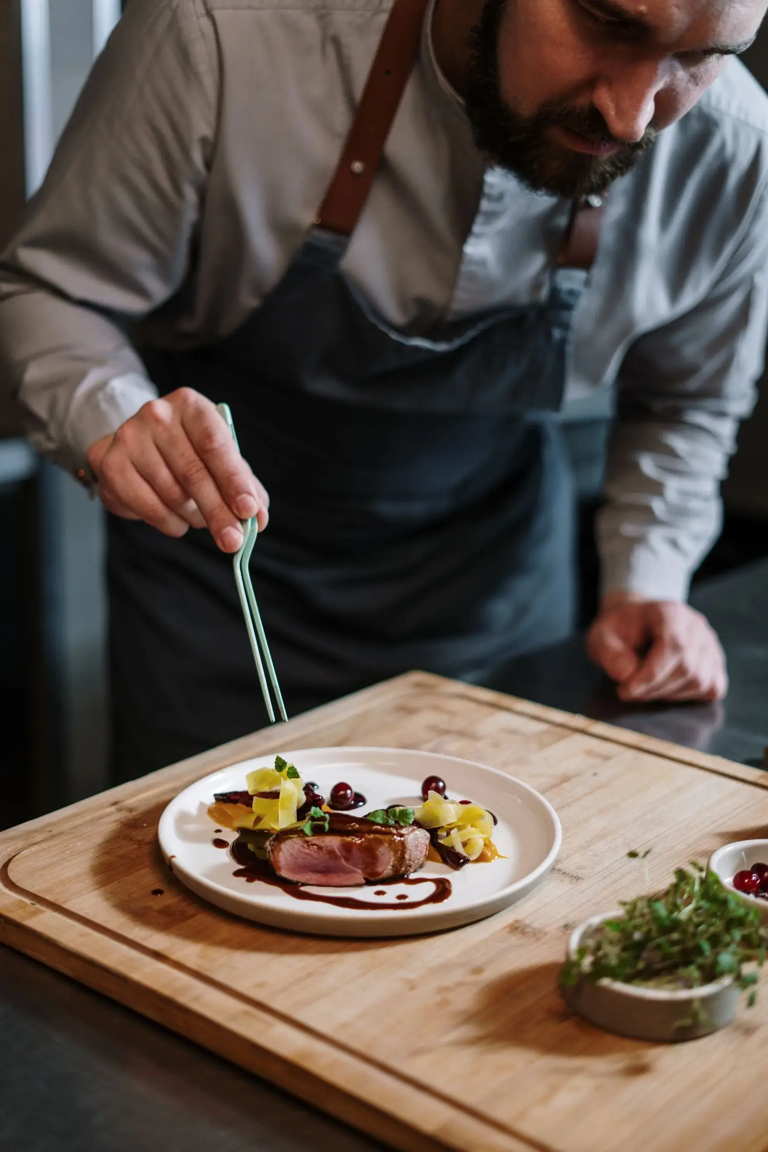 Chef plating a dish in the restaurant kitchen